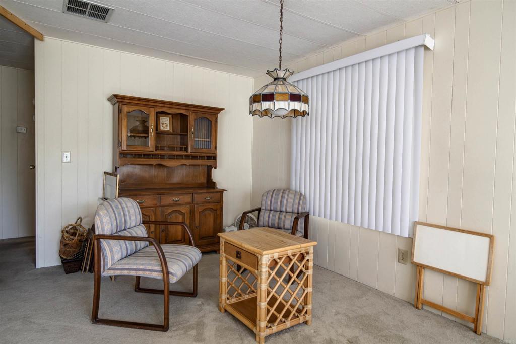 1010 Palm Canyon Drive, Unit 159 Borrego Springs, CA 92004 - Photo 6 of 25 a living room with furniture and a chandelier