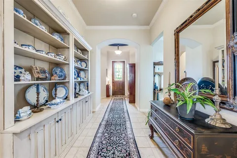 a kitchen with granite countertop a stove a sink and a refrigerator