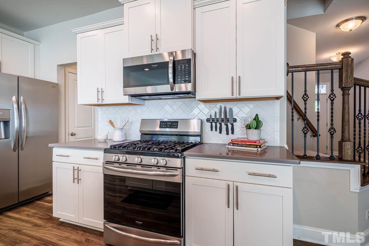 1007 Longitude Drive Durham, NC 27713 - Photo 11 of 35 a kitchen with stainless steel appliances granite countertop a stove a microwave and a refrigerator