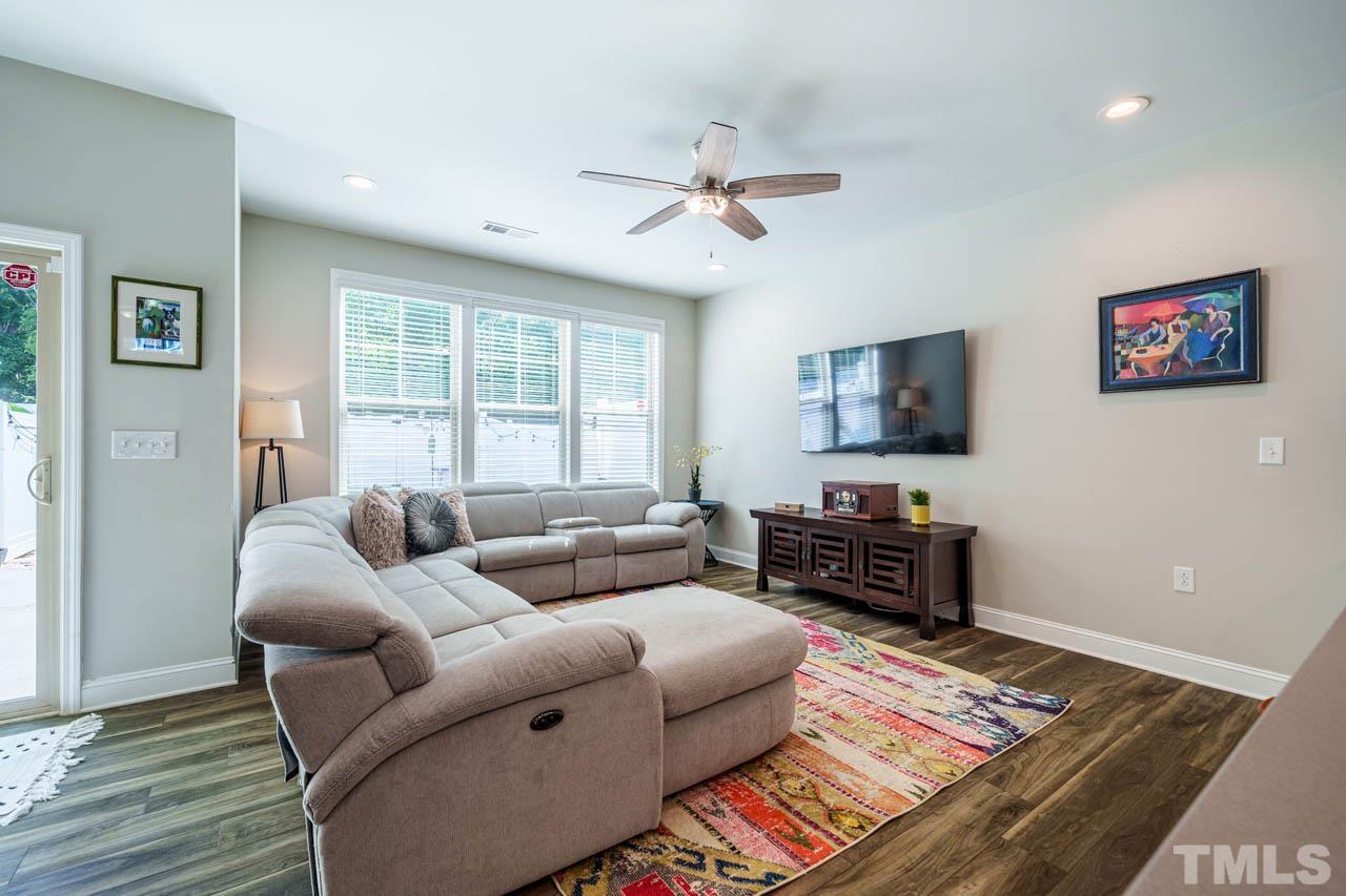 1007 Longitude Drive Durham, NC 27713 - Photo 13 of 35 a living room with furniture and a flat screen tv