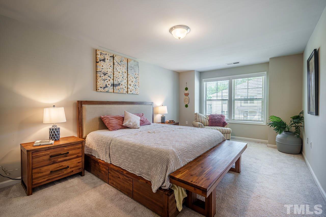 1007 Longitude Drive Durham, NC 27713 - Photo 19 of 35 a bedroom with a bed and wooden floor