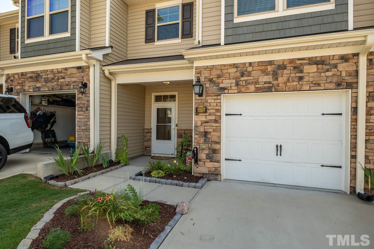 1007 Longitude Drive Durham, NC 27713 - Photo 2 of 35 a front view of a house with a yard and garage