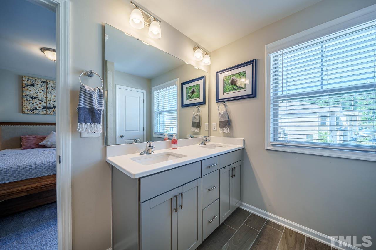 1007 Longitude Drive Durham, NC 27713 - Photo 23 of 35 a bathroom with a sink and a mirror