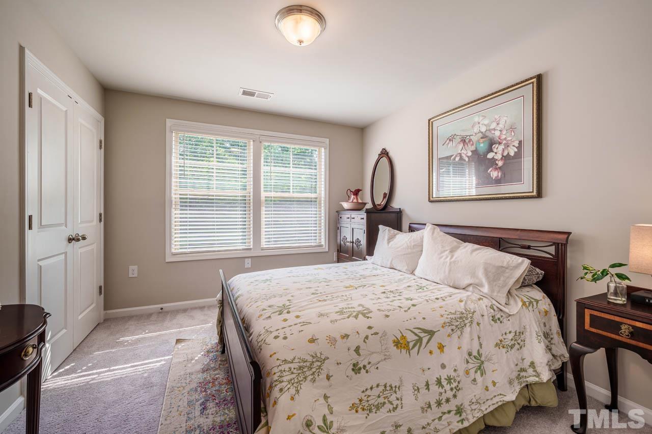 1007 Longitude Drive Durham, NC 27713 - Photo 26 of 35 a bedroom with a bed and a painting on the wall