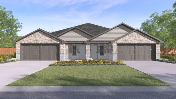 a front view of a house with a garden and garage