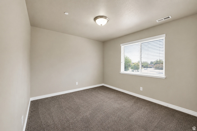 909 South Main Street, Unit G Layton, UT 84041 - Photo 13 of 25 Carpeted room with neutral painted walls and white trim