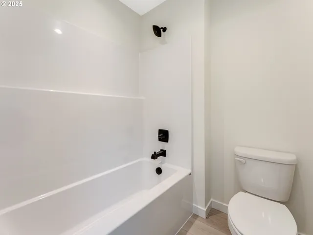 a bathroom with a toilet and a bathtub