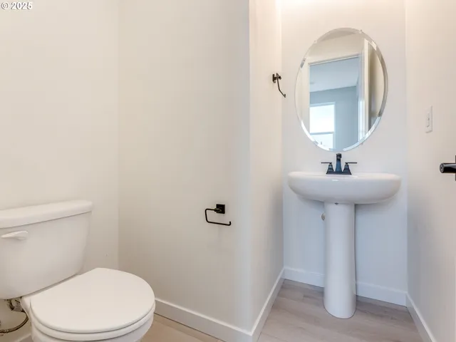 a bathroom with a sink toilet and a mirror