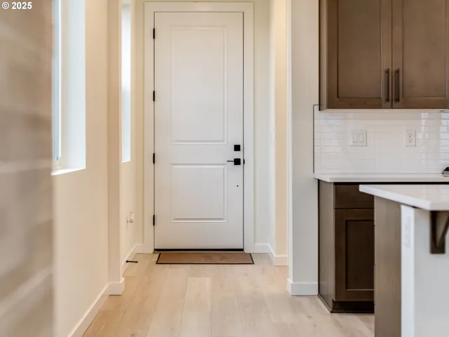 a view of an entryway with kitchen