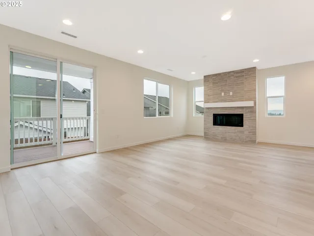an empty room with windows and cabinet