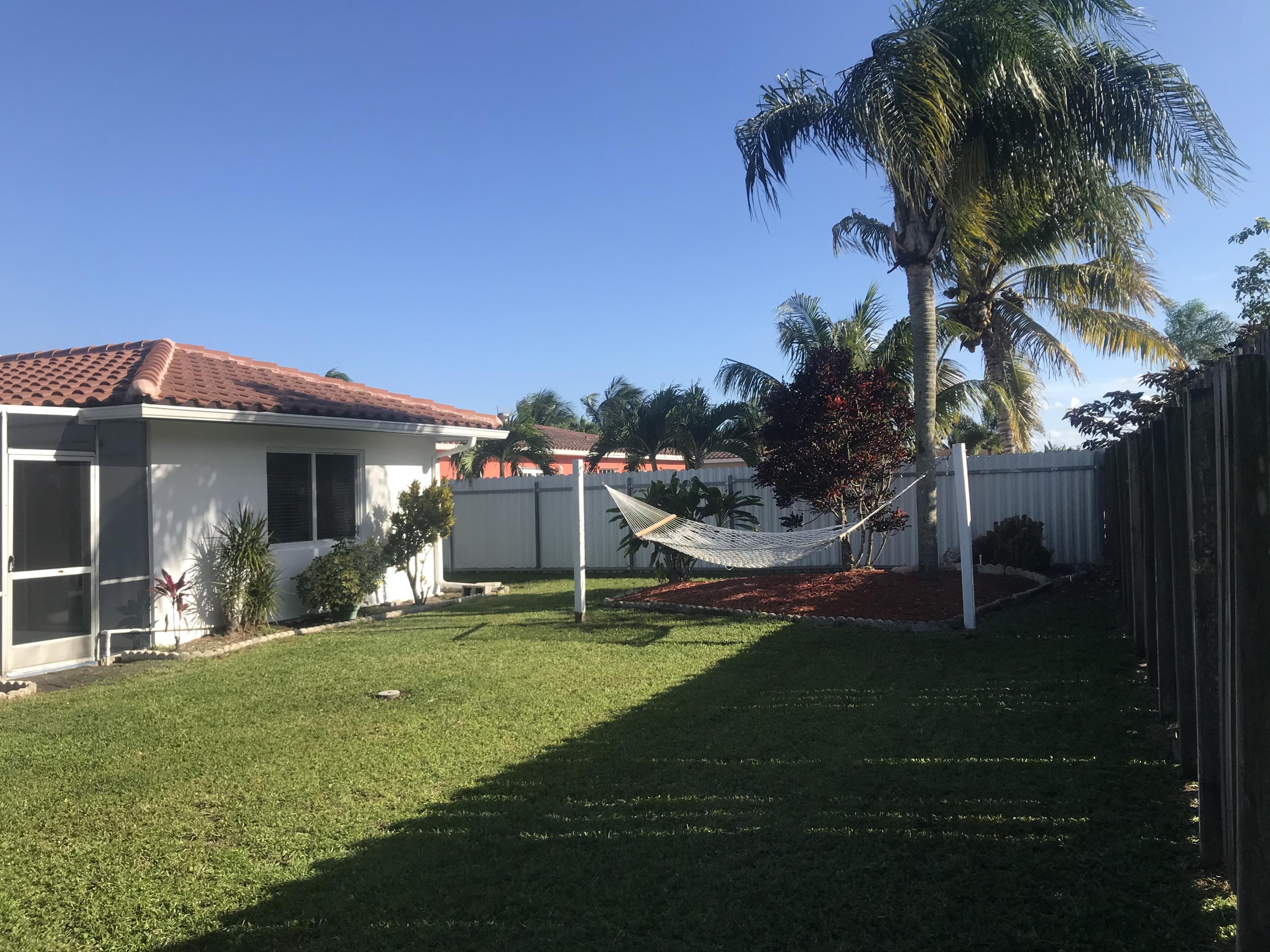 22307 Doran Avenue Boca Raton, FL 33428 - Photo 17 of 25 a view of a house with a yard porch and sitting area