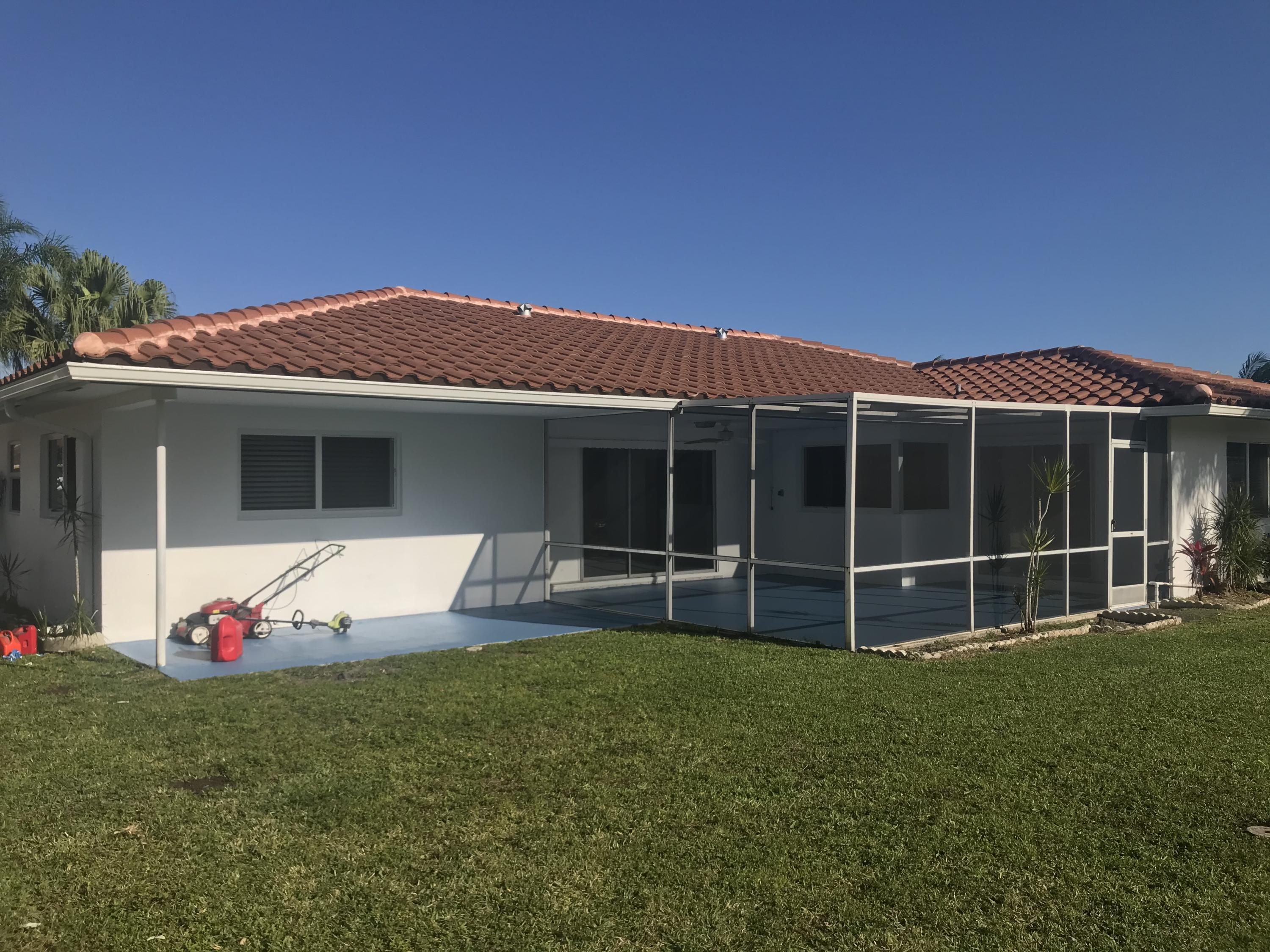 22307 Doran Avenue Boca Raton, FL 33428 - Photo 18 of 25 a front view of a house with a garden and yard