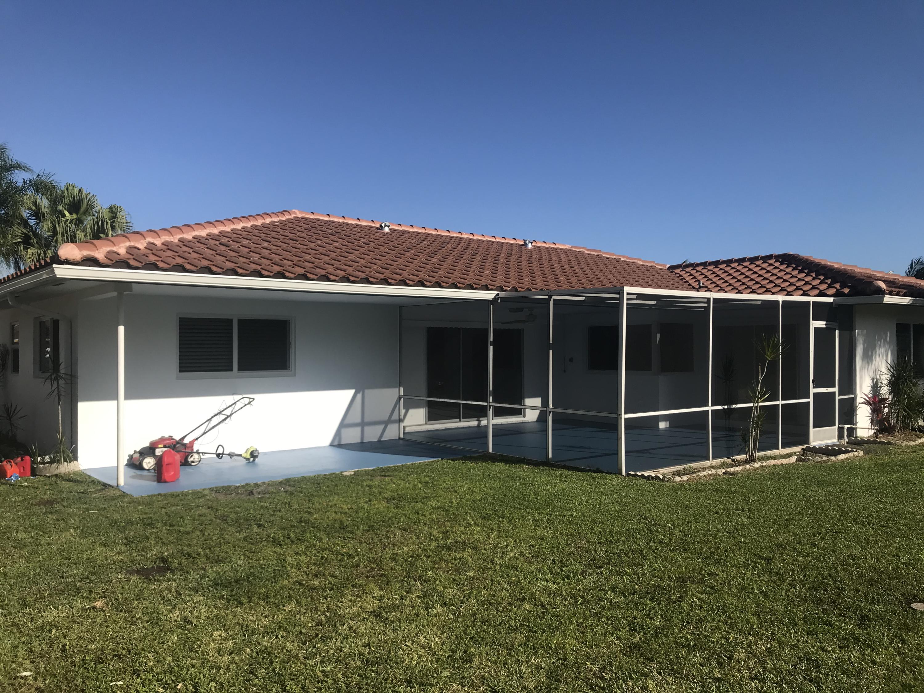 22307 Doran Avenue Boca Raton, FL 33428 - Photo 22 of 25 a front view of a house with a yard