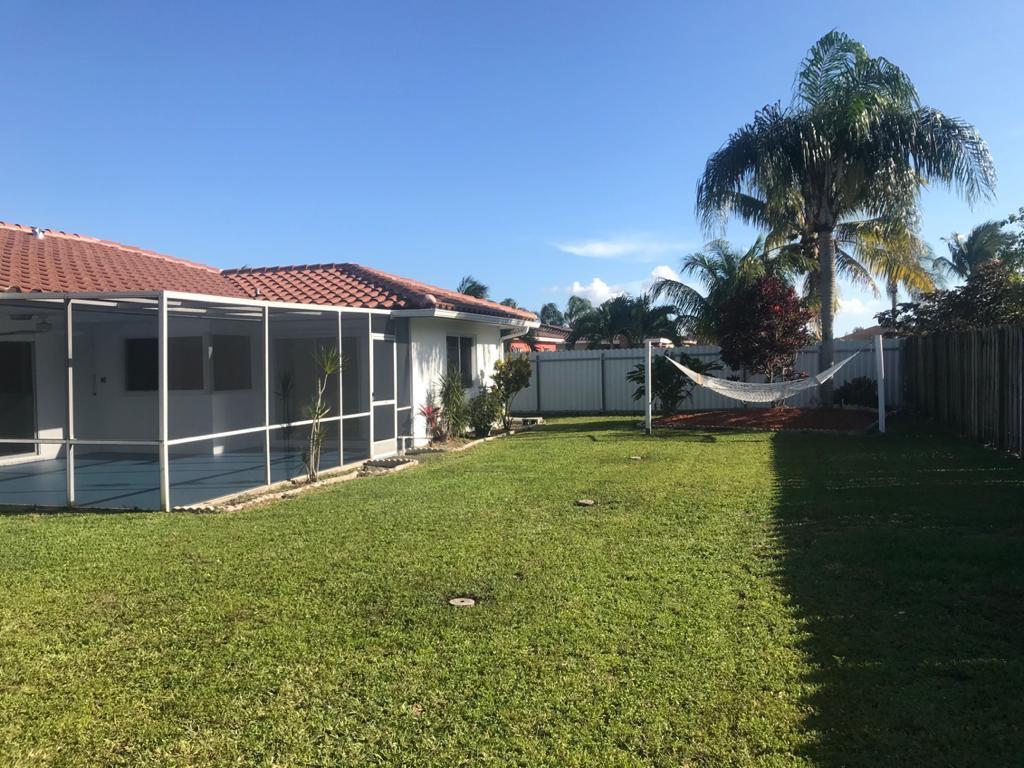 22307 Doran Avenue Boca Raton, FL 33428 - Photo 4 of 25 a view of a house with a garden and yard
