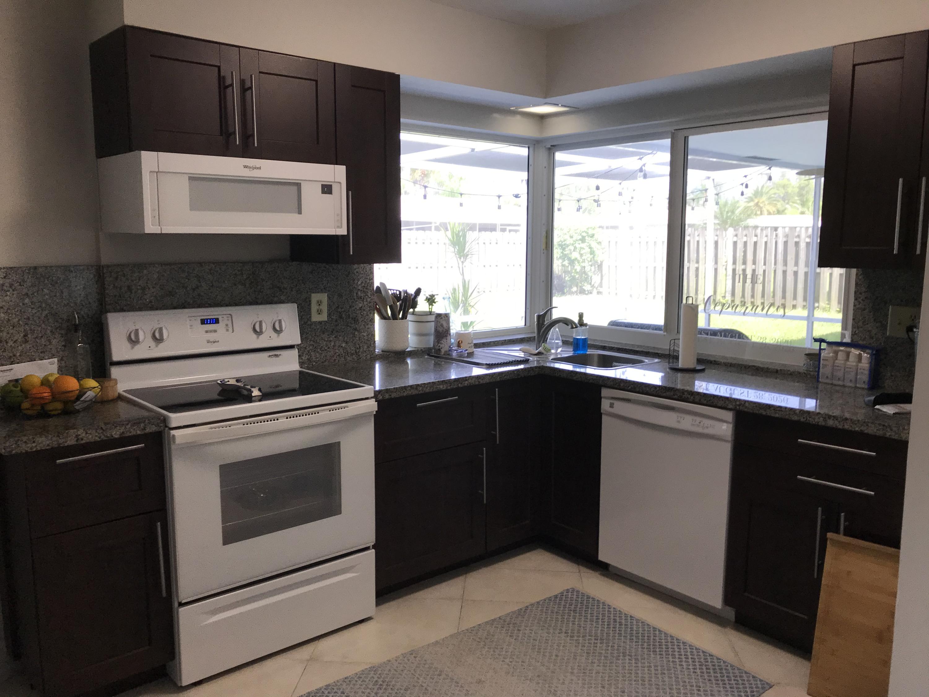 22307 Doran Avenue Boca Raton, FL 33428 - Photo 7 of 25 a kitchen with a sink stove and microwave