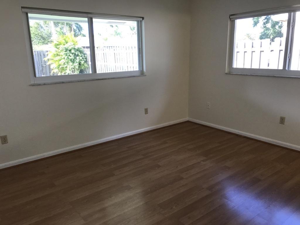 22307 Doran Avenue Boca Raton, FL 33428 - Photo 10 of 25 an empty room with wooden floor and windows