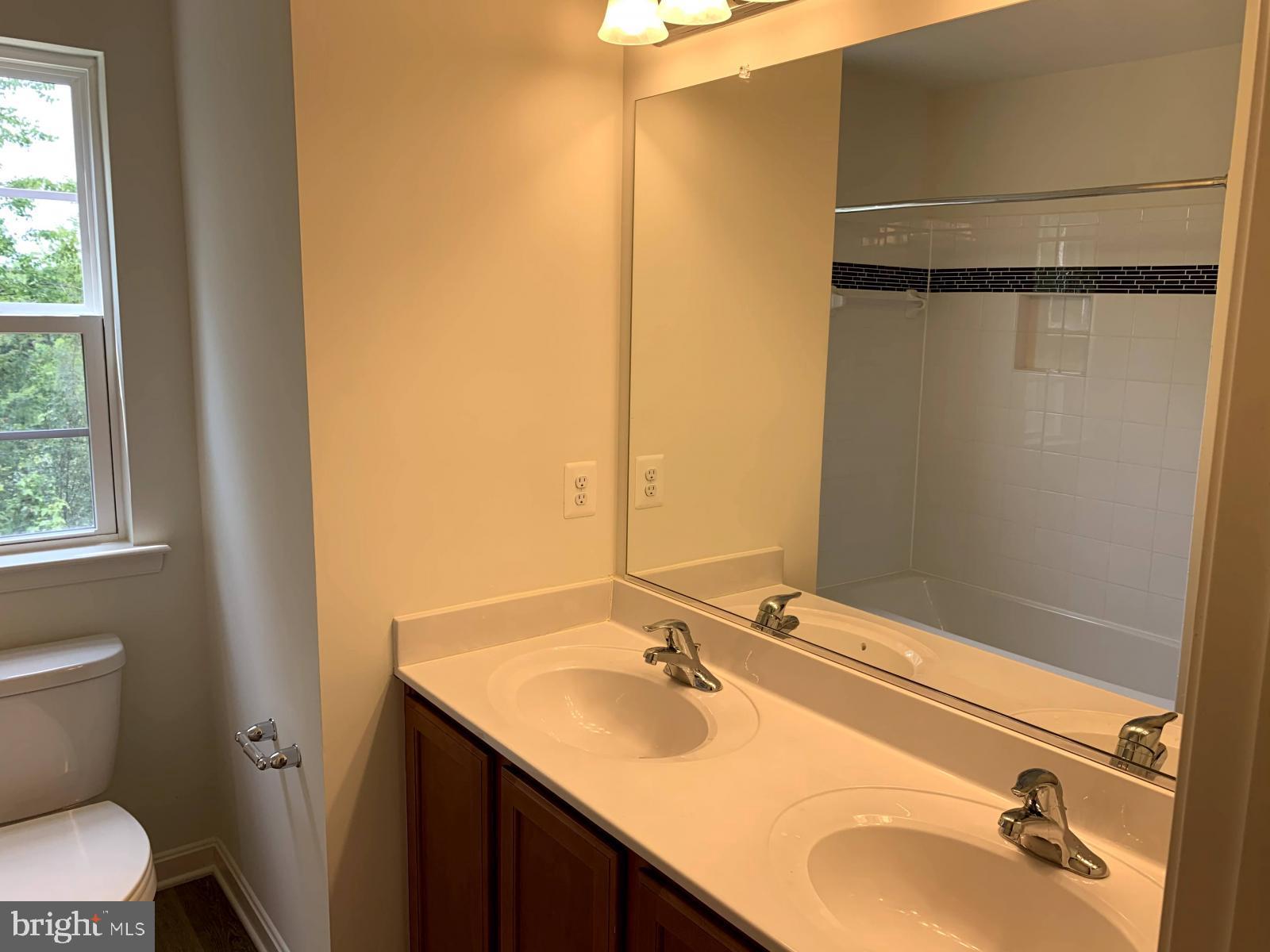 263 Trails Way Joppa, MD 21085 - Photo 16 of 27 a bathroom with a sink and a mirror