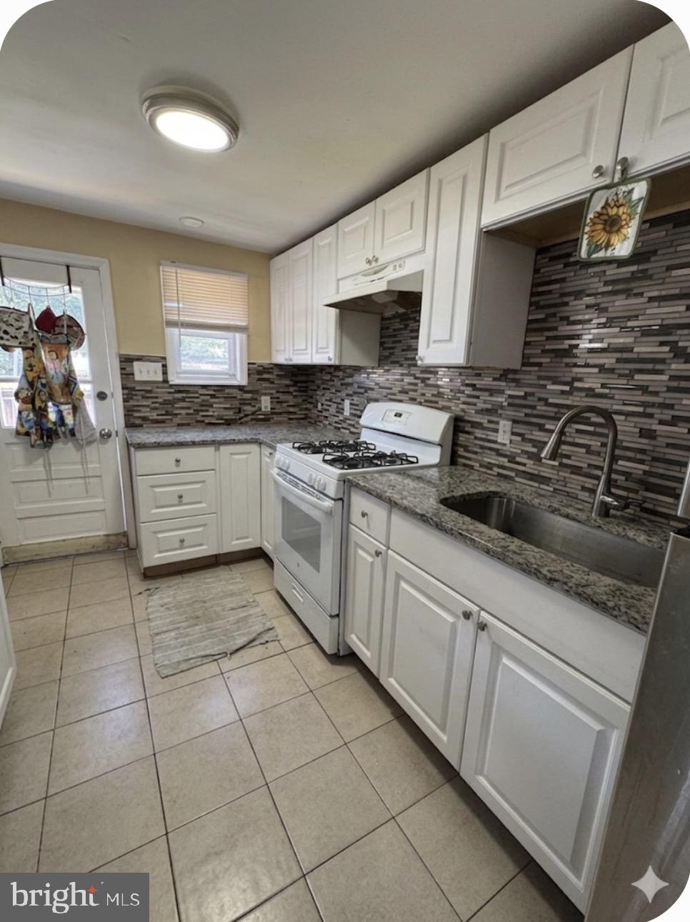 1515 Collings Road Camden, NJ 08104 - Photo 7 of 23 a kitchen with stainless steel appliances granite countertop a stove a sink and a microwave