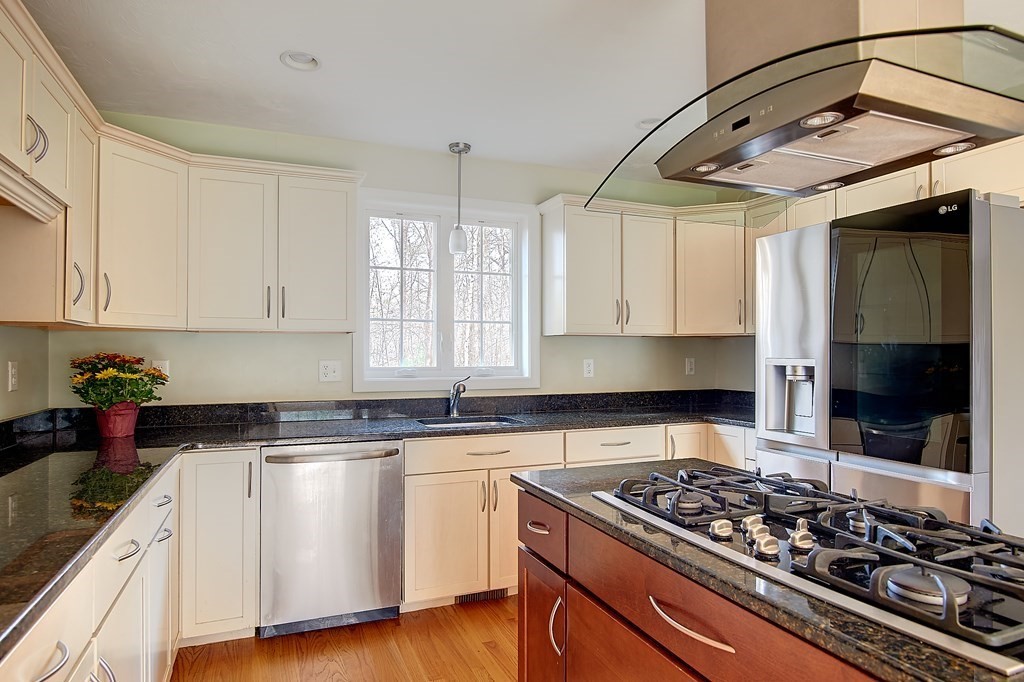 4 Alyssa Drive Townsend, MA 01469 - Photo 8 of 35 a kitchen with stainless steel appliances a stove a sink and white cabinets