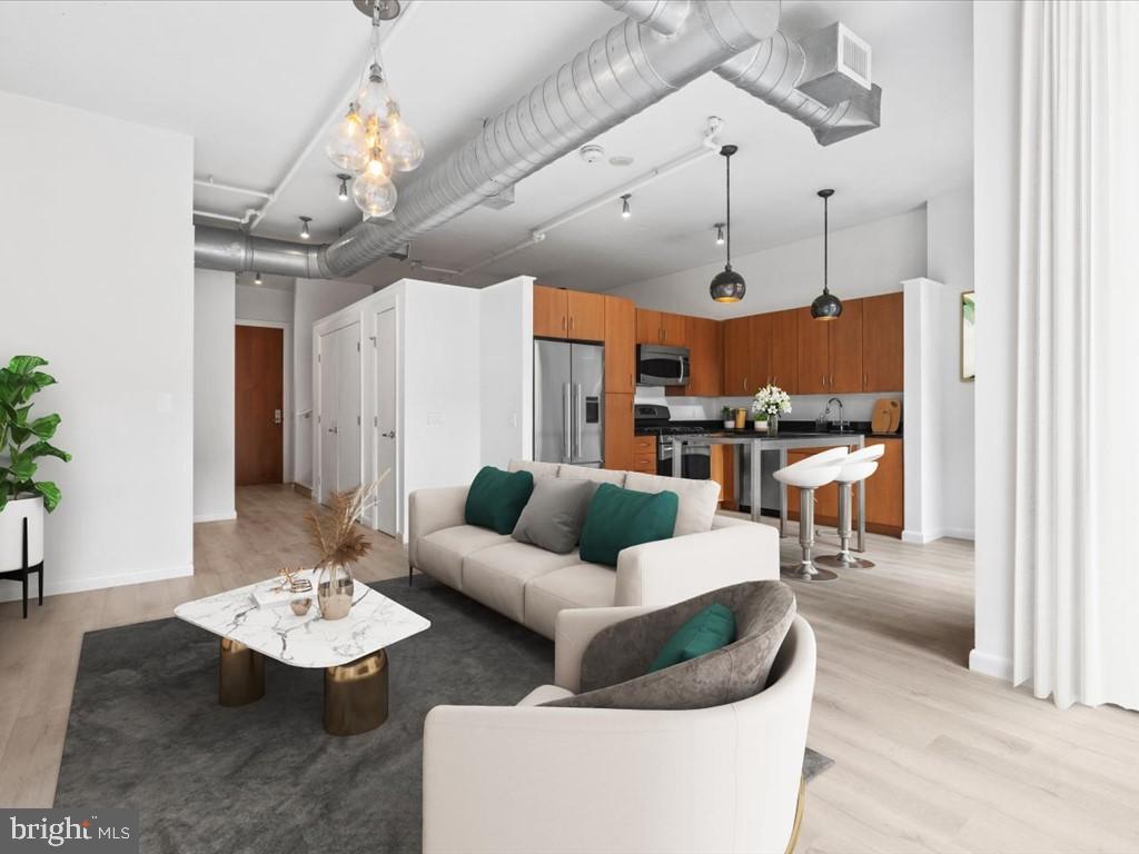 811 4th Street Northwest, Unit 608 Washington, DC 20001 - Photo 5 of 22 a living room with furniture and a chandelier