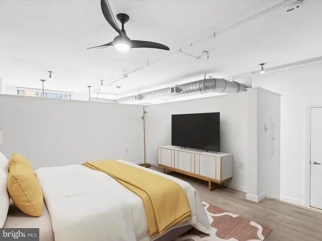 a bedroom with double bed and a flat tv screen