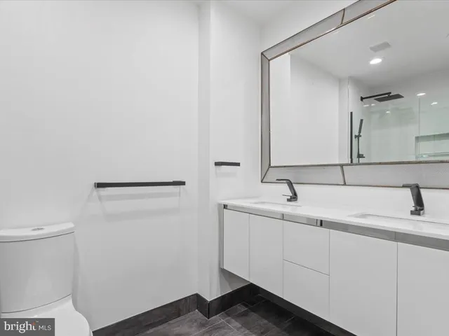a bathroom with a toilet sink and mirror