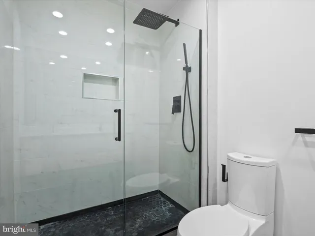 a bathroom with a toilet and a shower