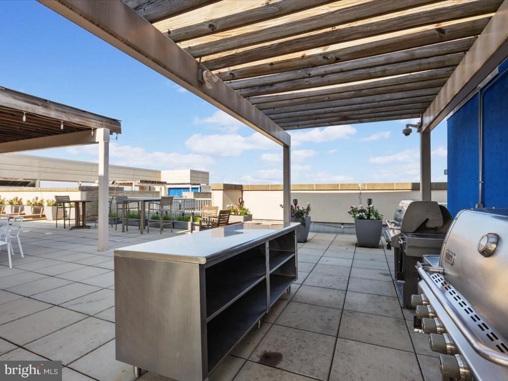 811 4th Street Northwest, Unit 608 Washington, DC 20001 - Photo 10 of 22 a kitchen with a stove a sink and a microwave