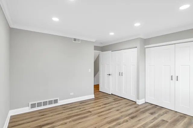 a view of an empty room with wooden floor