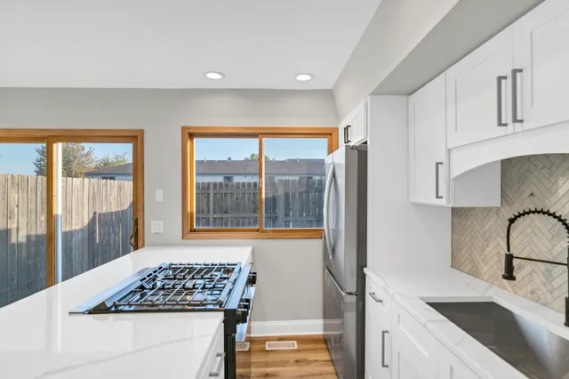 a kitchen that has a sink and a stove