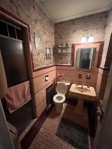 a bathroom with a sink toilet and mirror