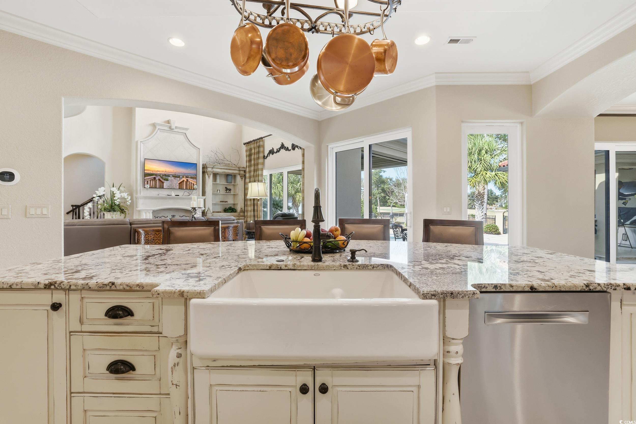 9552 Lugano Court Myrtle Beach, SC 29579 - Photo 40 of 40 Kitchen featuring cream cabinets, arched walkways, light stone countertops, stainless steel dishwasher, and open floor plan