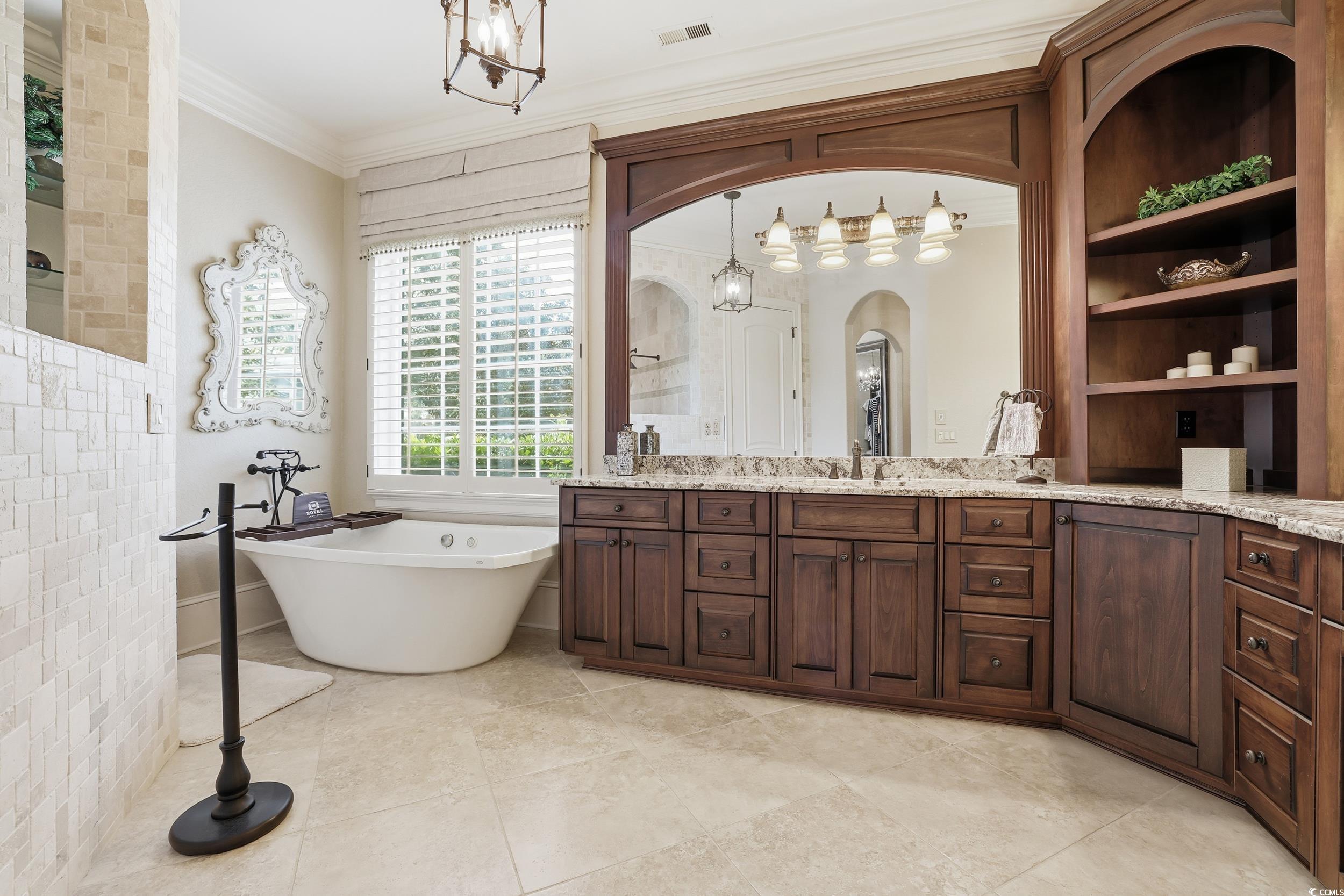 9552 Lugano Court Myrtle Beach, SC 29579 - Photo 22 of 40 Bathroom with a freestanding bath, vanity, crown molding, walk in shower, and a chandelier
