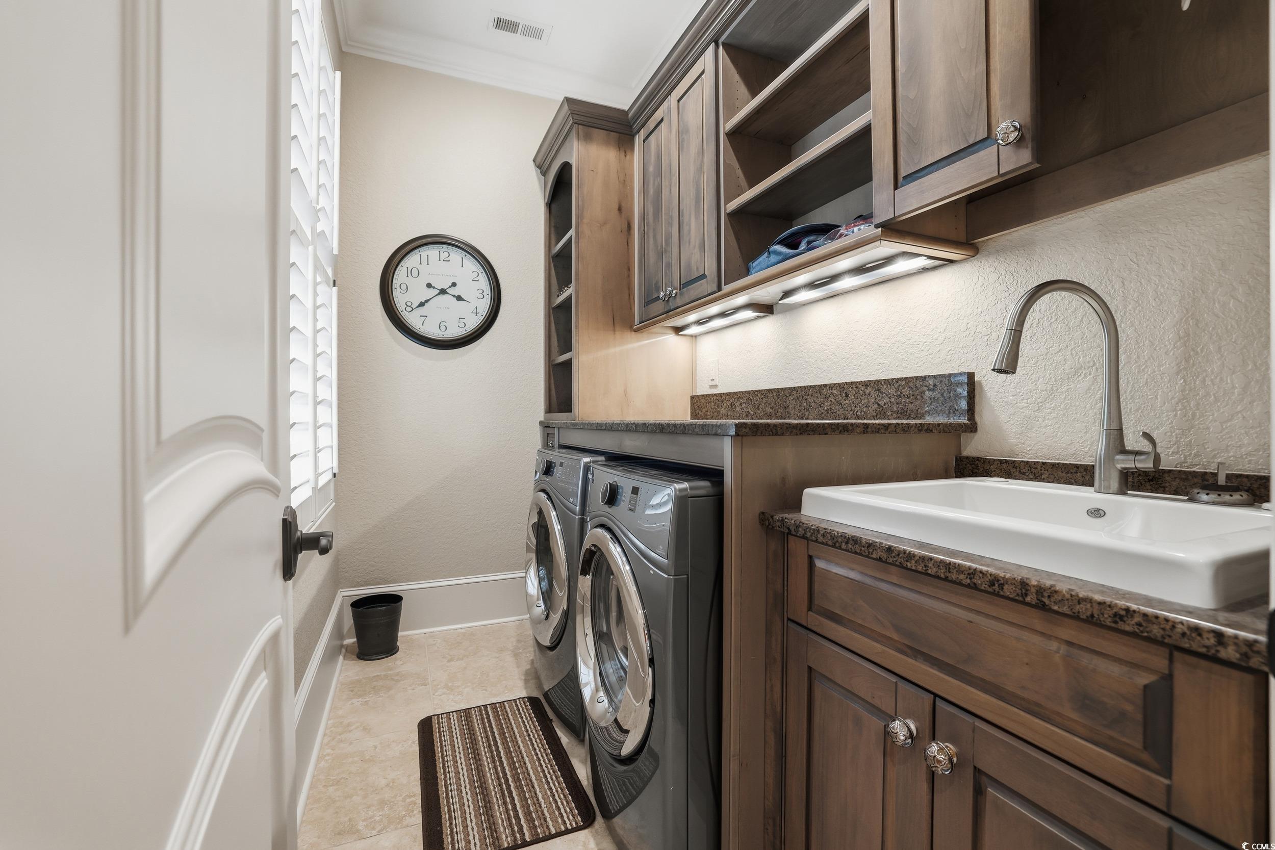 9552 Lugano Court Myrtle Beach, SC 29579 - Photo 24 of 40 Laundry room with a textured wall, separate washer and dryer, ornamental molding, cabinet space, and light tile patterned floors