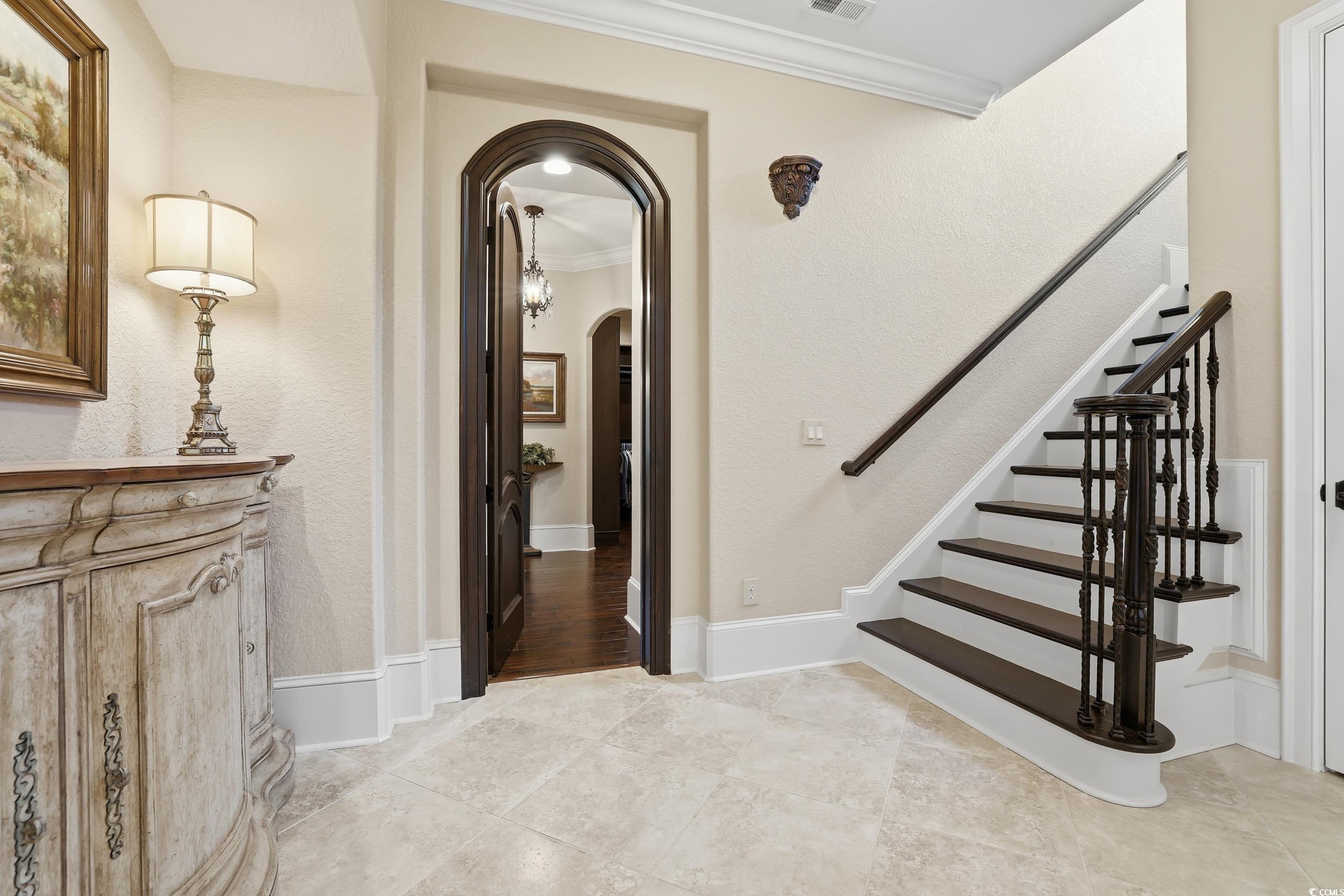 9552 Lugano Court Myrtle Beach, SC 29579 - Photo 26 of 40 Staircase with arched walkways and ornamental molding