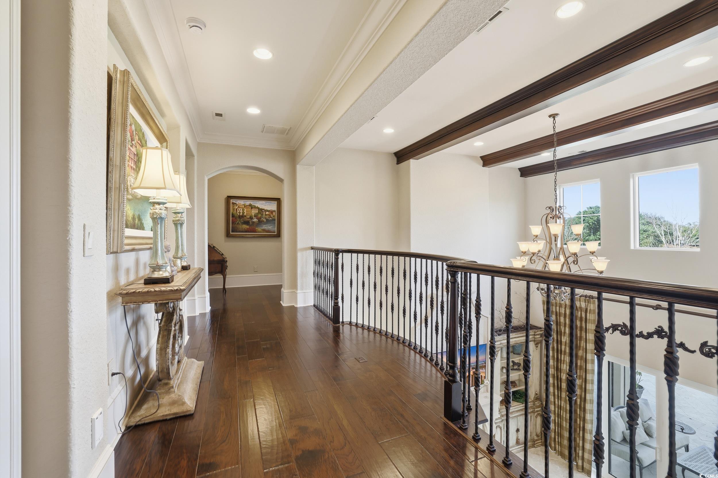 9552 Lugano Court Myrtle Beach, SC 29579 - Photo 29 of 40 Hall featuring ornamental molding, dark wood-type flooring, a chandelier, beamed ceiling, and arched walkways