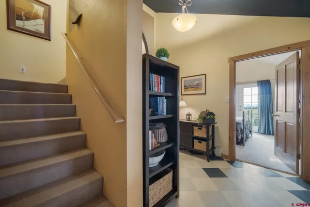a view of staircase with lots of frames on wall
