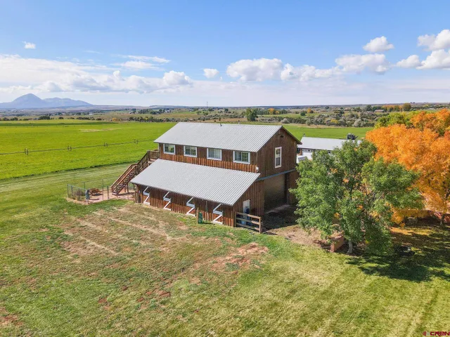 an aerial view of a house with a lake view