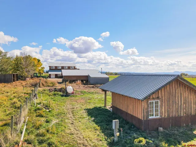 a aerial view of a house with table and chairs