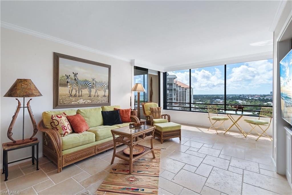 5555 Heron Point Drive, Unit 1202 Naples, FL 34108 - Photo 11 of 36 a living room with furniture and a large window