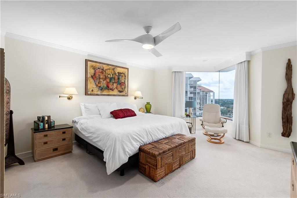 5555 Heron Point Drive, Unit 1202 Naples, FL 34108 - Photo 20 of 36 a bedroom with a bed couch and a window