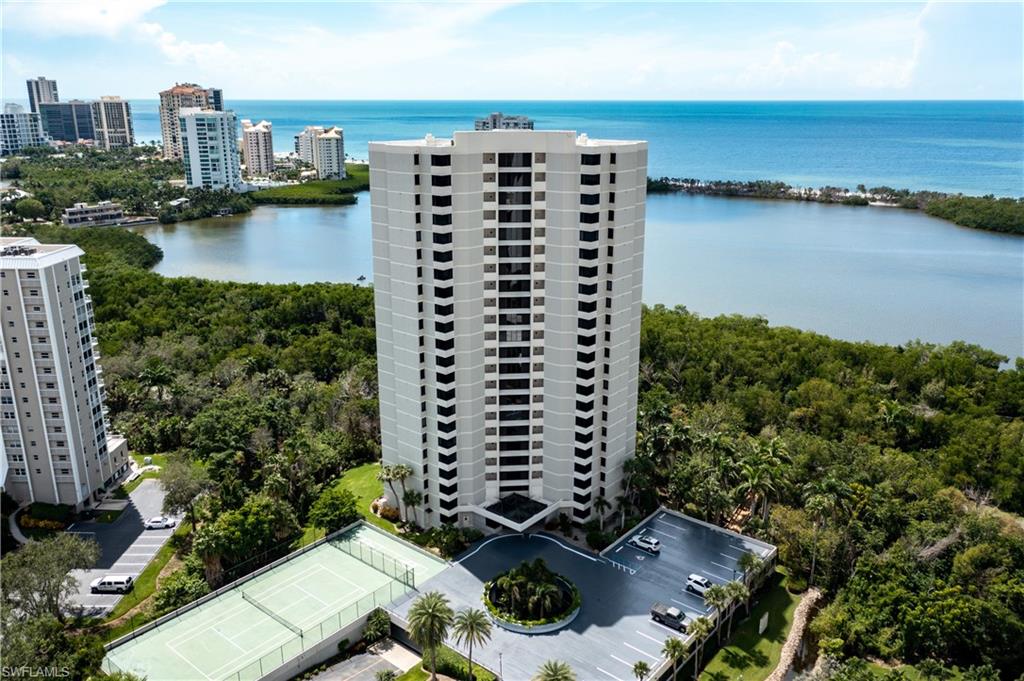 5555 Heron Point Drive, Unit 1202 Naples, FL 34108 - Photo 2 of 36 a view of a lake with tall buildings