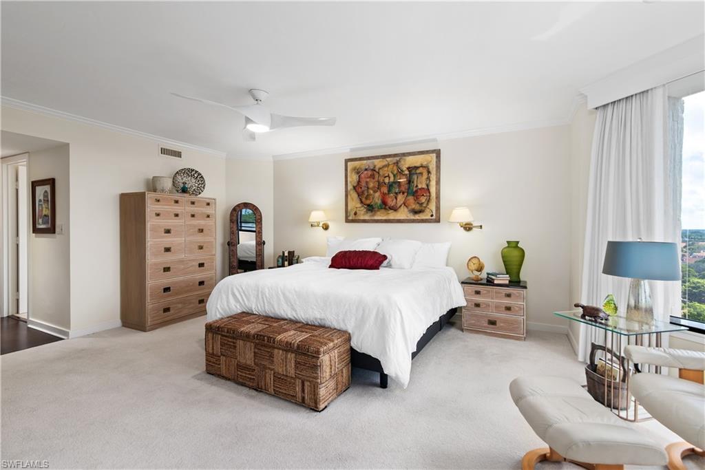 5555 Heron Point Drive, Unit 1202 Naples, FL 34108 - Photo 21 of 36 a spacious bedroom with a bed a couch and dresser