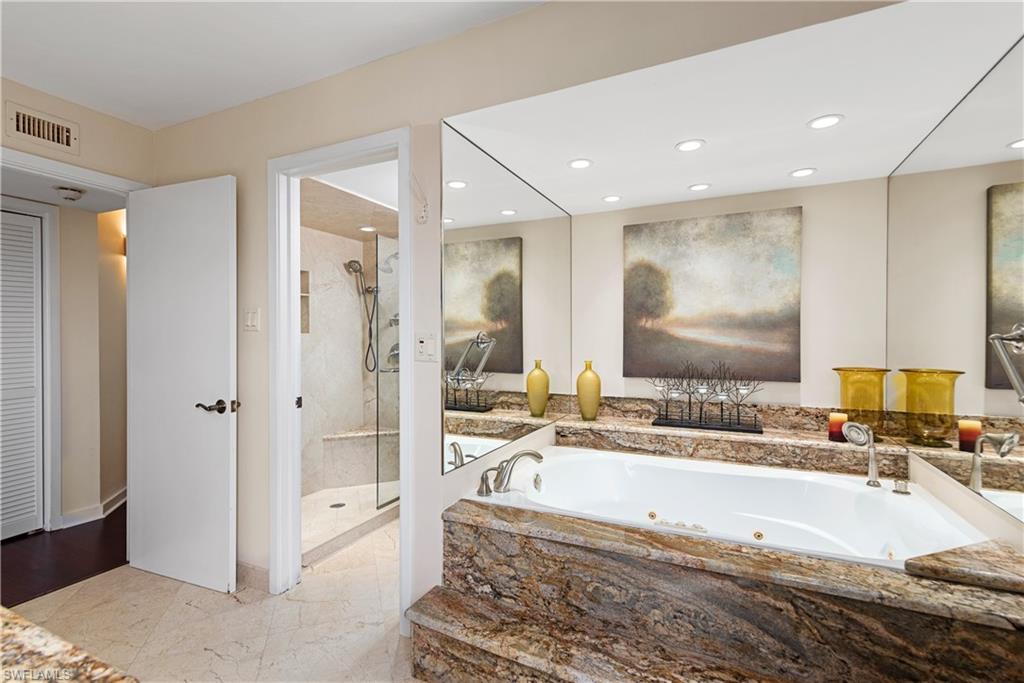5555 Heron Point Drive, Unit 1202 Naples, FL 34108 - Photo 23 of 36 a spacious bathroom with a large tub shower and sink