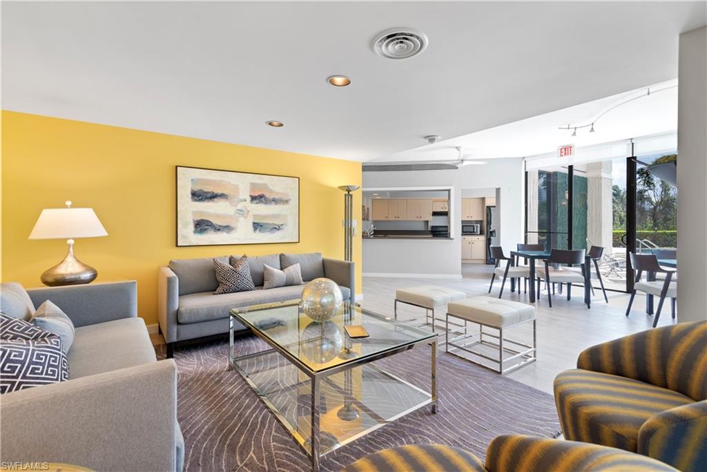 5555 Heron Point Drive, Unit 1202 Naples, FL 34108 - Photo 29 of 36 a living room with furniture and wooden floor