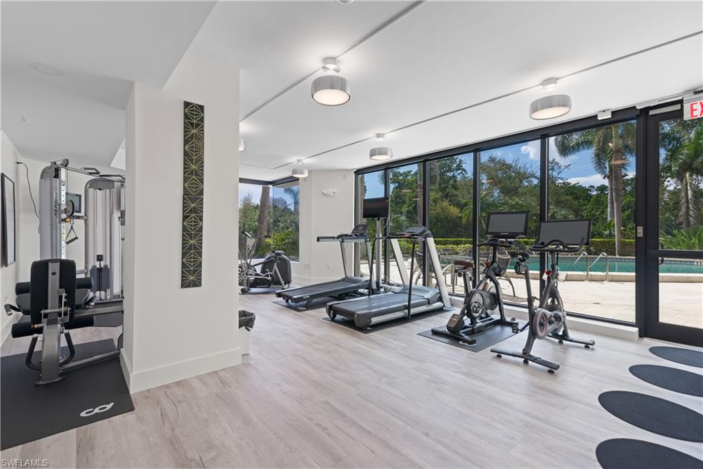 5555 Heron Point Drive, Unit 1202 Naples, FL 34108 - Photo 30 of 36 a view of a livingroom with couch and floor to ceiling window