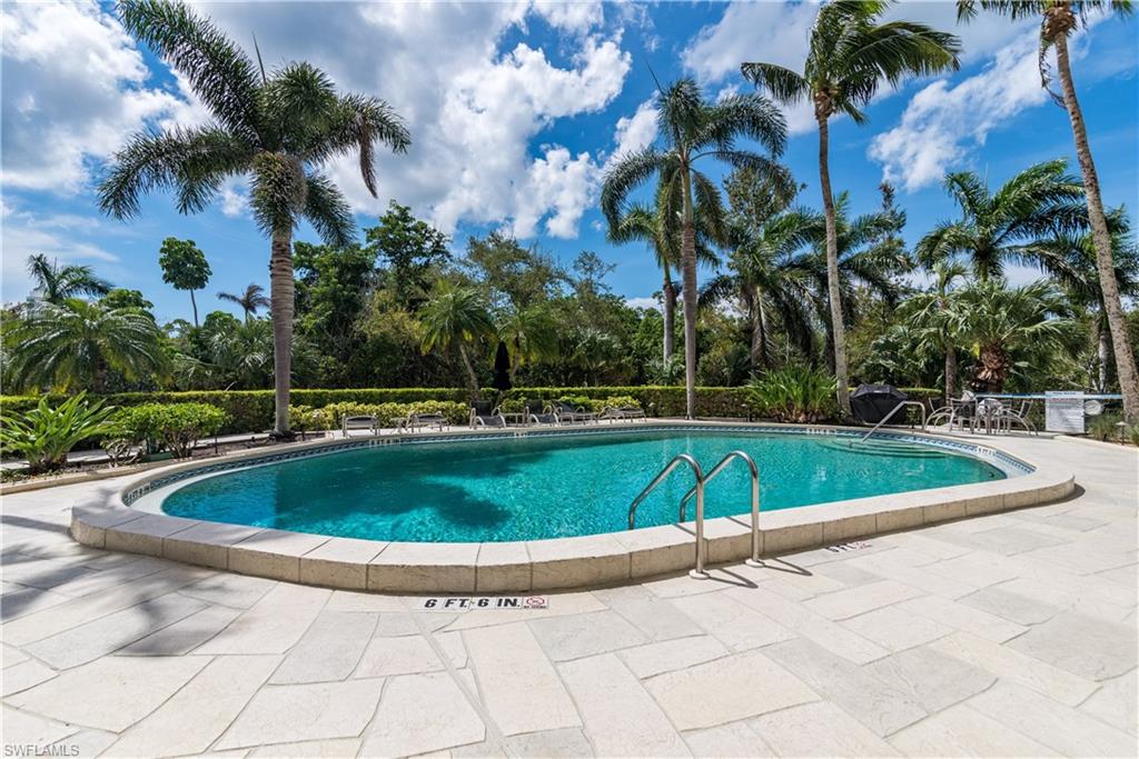 5555 Heron Point Drive, Unit 1202 Naples, FL 34108 - Photo 32 of 36 a view of a swimming pool with an outdoor space
