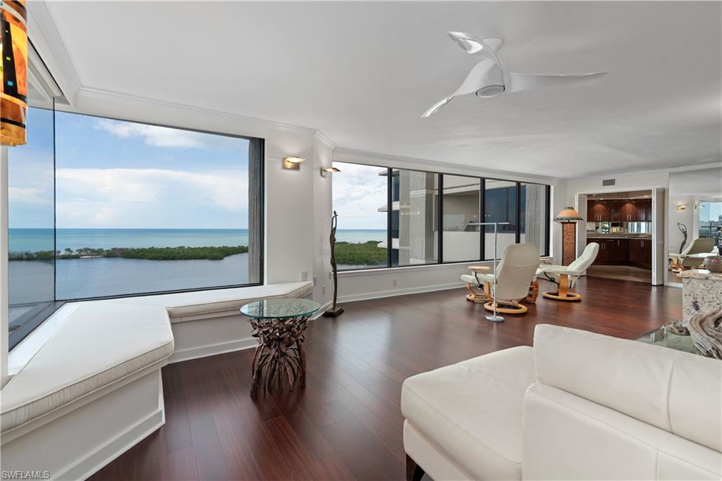 5555 Heron Point Drive, Unit 1202 Naples, FL 34108 - Photo 7 of 36 a living room with fireplace furniture and a large window