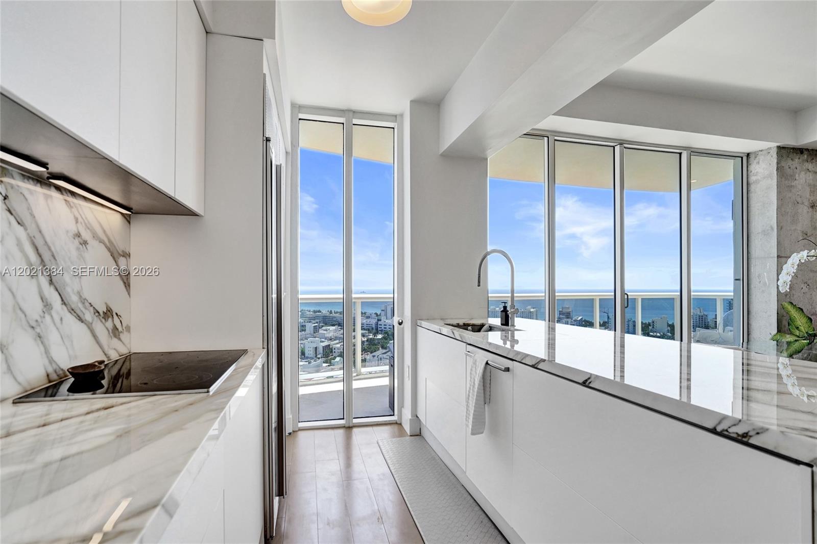400 Alton Road, Unit PH11 Miami Beach, FL 33139 - Photo 19 of 49 a kitchen with a sink and large window