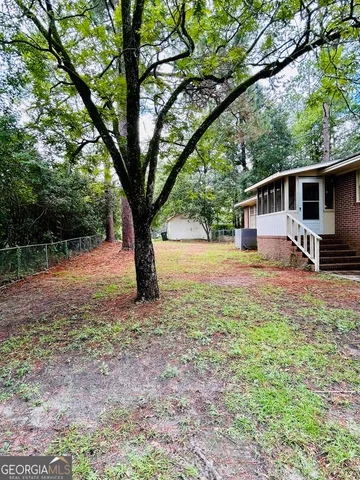 a backyard of a house with barbeque oven